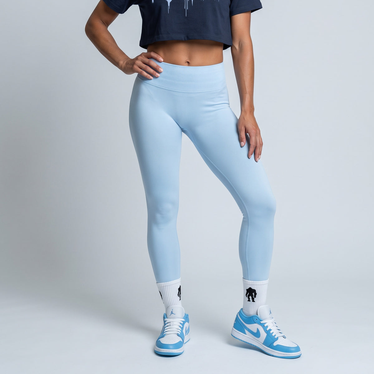 Navy baby tee with an Ice Blue drip logo, full outfit