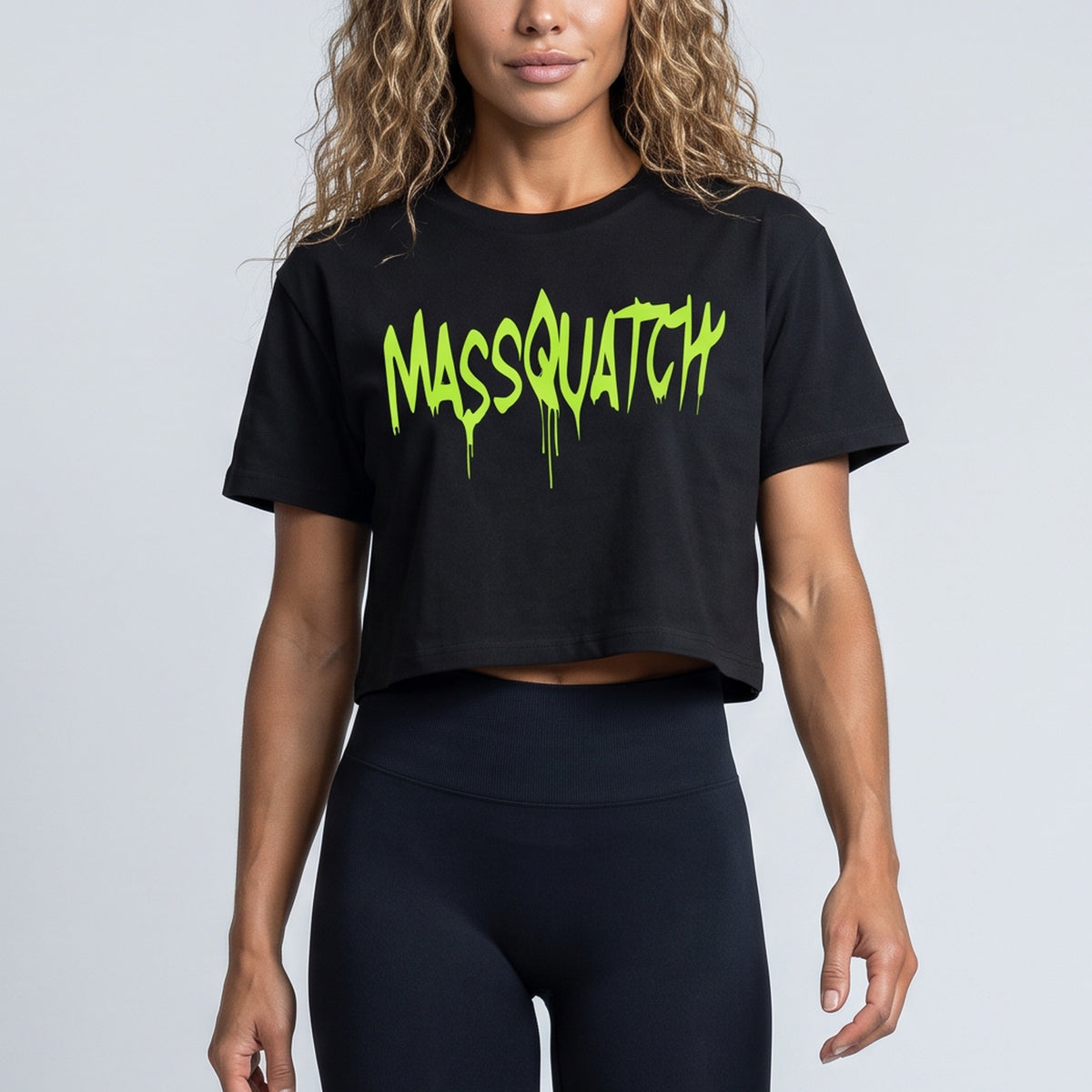 Black baby tee with a Hazard Lime drip logo, print close-up